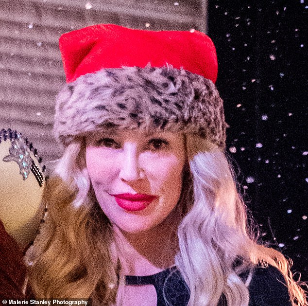 Brandi photographed at the event wearing the festive hat, perfect for the holiday season.