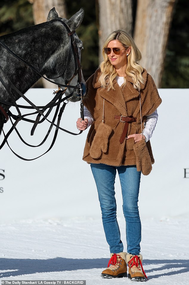 Nicky (born Nicholai) also greeted a gray horse while wearing a white knit sweater, blue jeans and brown hiking boots.