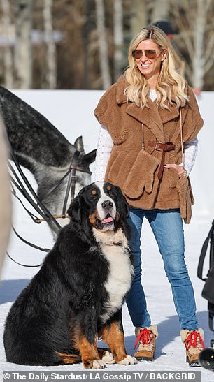 She was wearing a cute brown furry vest with matching gloves.