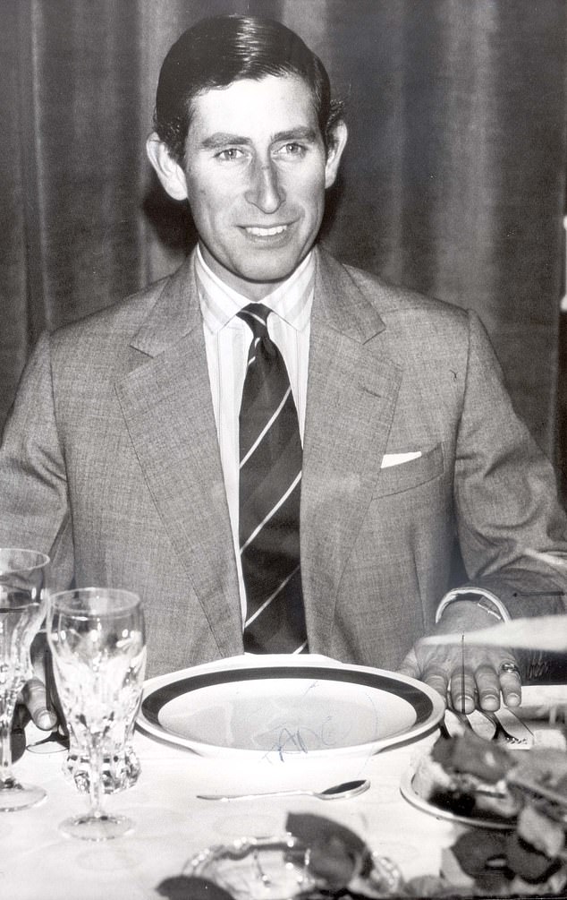 Prince Charles sitting at the table after attending a Christmas service in 1982