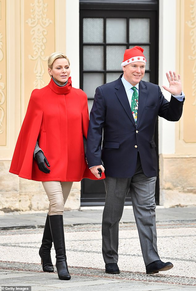 Princess Charlene and Prince Albert of Monaco, dressed in festive hats and ties, in 2017