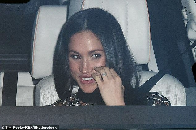 Meghan smiled as she was photographed in the car leaving the family lunch.