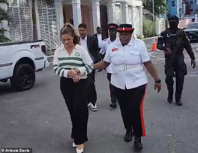 Footage obtained by DailyMail.com shows the blonde housewife being taken to the infamous Fox Hill prison - one of the grimmest incarcerations in the Caribbean