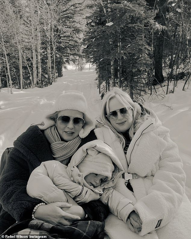 Another postcard-perfect photo, it showed the close-knit family happily cuddled up as they posed in the snow.