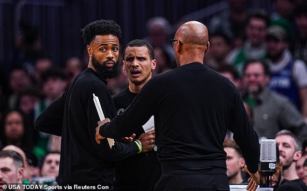 Joe Mazzulla is held back by assistant coach Sam Cassell (right) while reacting to a technical foul.