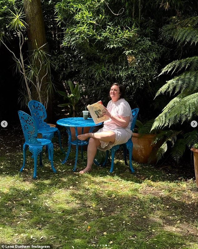 The outdoor space features a bright blue table and chairs and is the perfect spot for a sunny day.