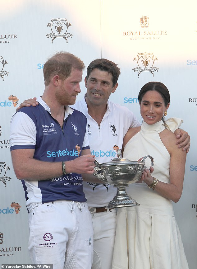 Meghan presents a trophy to her husband at a polo match in April