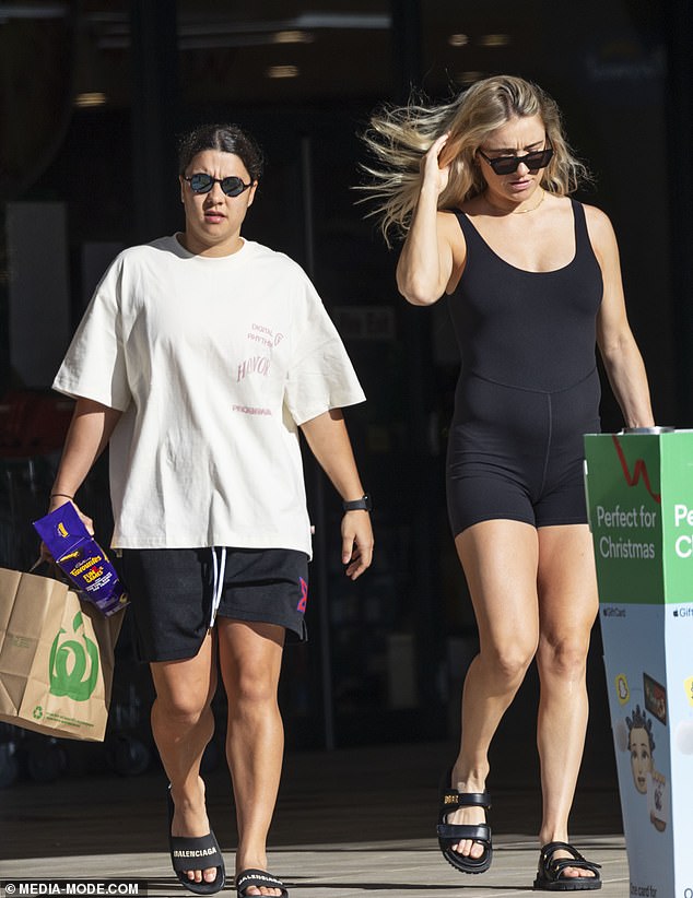 The Chelsea striker shielded her eyes with blue reflective glasses and carried a shopping bag in one hand as they picked up some Christmas essentials, including a box of chocolates.