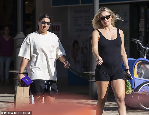 West Ham United midfielder Kristie completed her sports ensemble with a pair of black sandals and protected her eyes with dark square sunglasses.