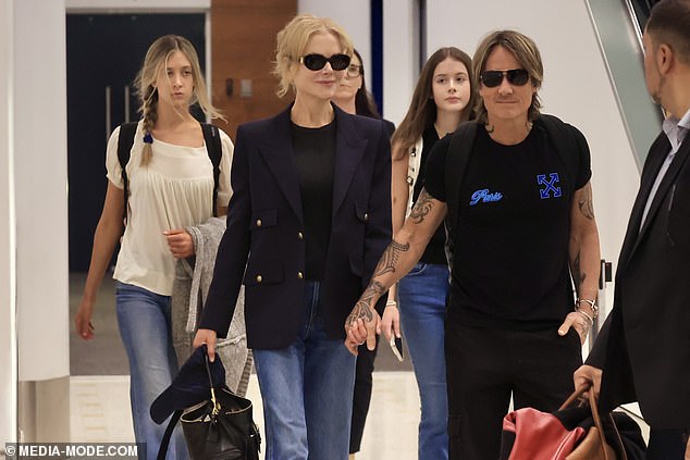 They were joined by their two teenage daughters, Sunday and Faith, who walked close behind them after they got off their long-haul flight.