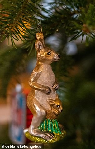 Hanging from the tree is a glass kangaroo with a joey in its pouch.