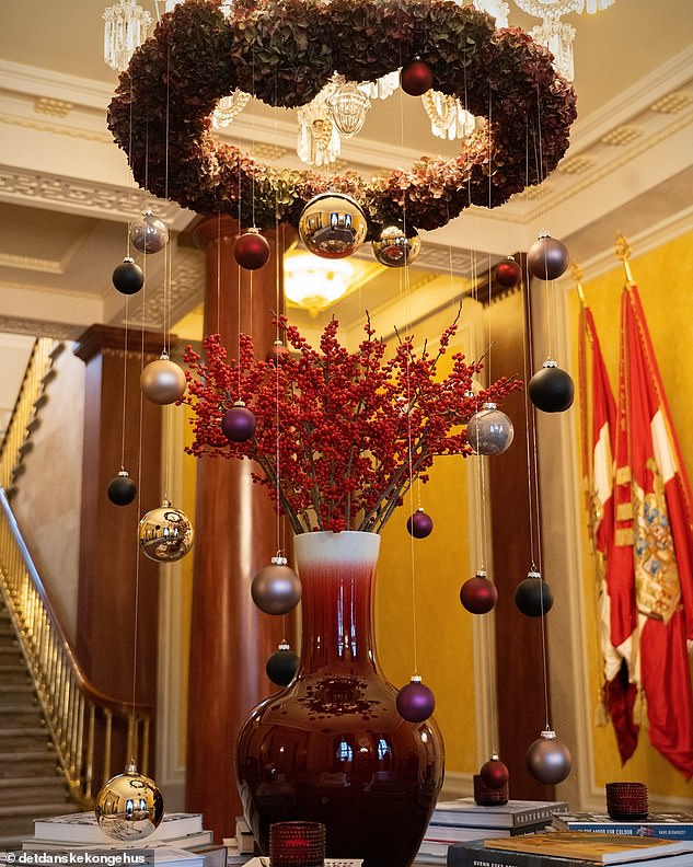 A magnificent display of ornaments hangs in the foyer of the royal residence.