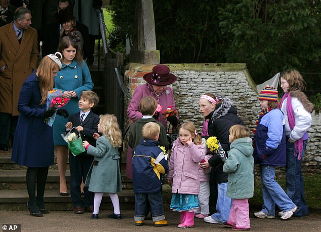 Queen Elizabeth II receives flowers from young children after attending the traditional Christmas Day church service in 2006.