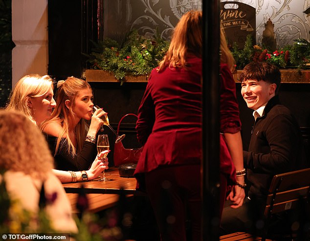 The family laughed inside the pub, with Darcey enjoying a glass of champagne.