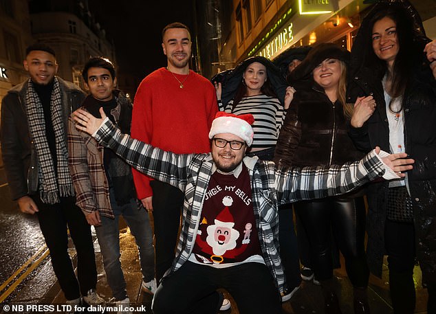 LEEDS: There is Christmas cheer everywhere as a man in a Santa hat (front) expresses his festive cheer