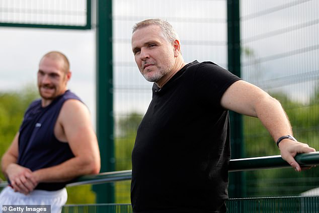 Peter (main, right) watches a Tyson press session at a school in Bolton in 2014.