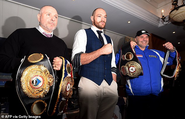 Peter (left), with Tyson and his father John (right) at a press conference in Bolton in 2015.