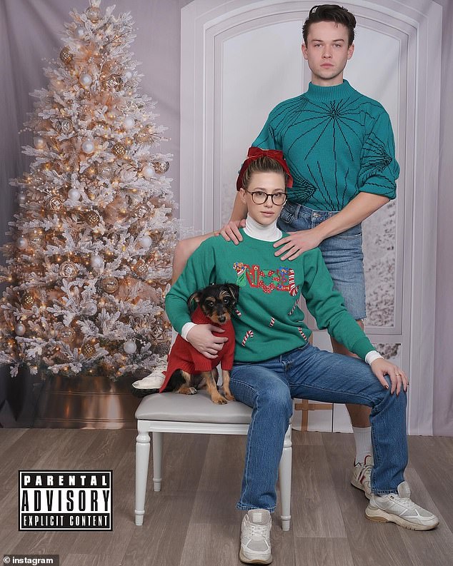 Reinhardt posed with her boyfriend Jack Martin. They wore green Christmas sweaters with jeans for a nerdy look as they were seen next to a tree.