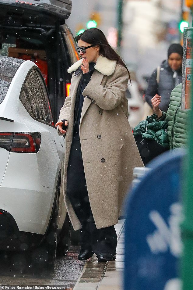 Anne layered her faux fur-trimmed outerwear over a leather jacket and black pants while shielding her eyes behind sunglasses.