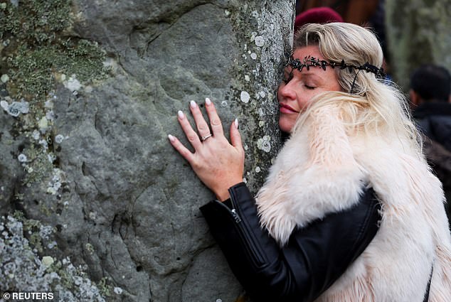 A reveler attends the winter solstice celebrations at the stone circle at Stonehenge today.