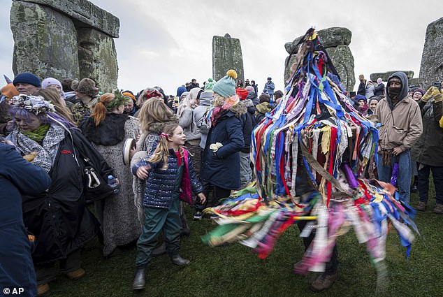 A ribbon-bedecked toy horse performs during the winter solstice celebrations at Stonehenge today.