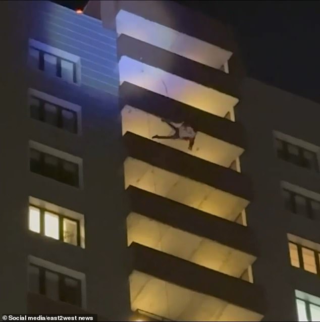 The man suddenly lost his grip and fell 70 meters, landing on a structure above the first floor