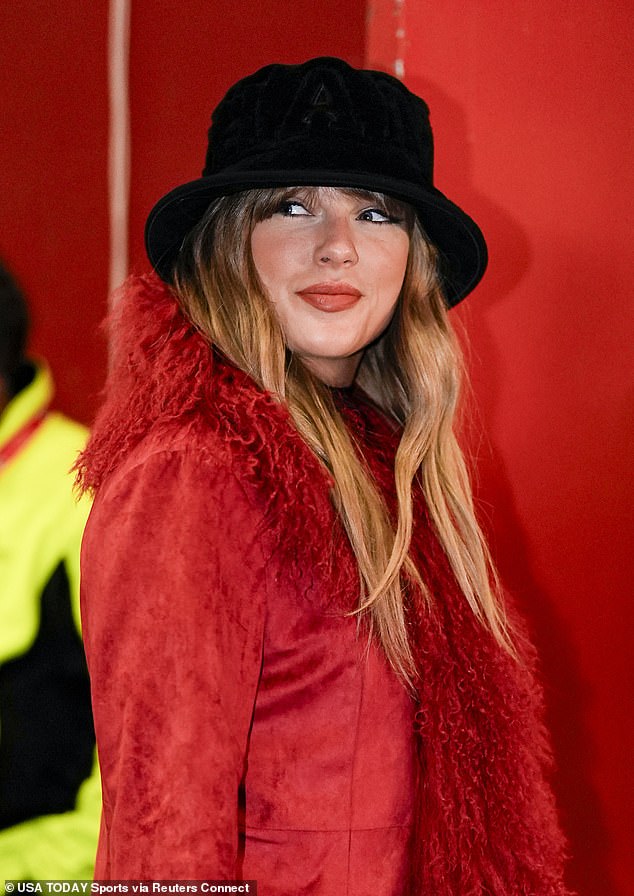 She wore a fluffy red jacket and black fedora for her return to Arrowhead Stadium