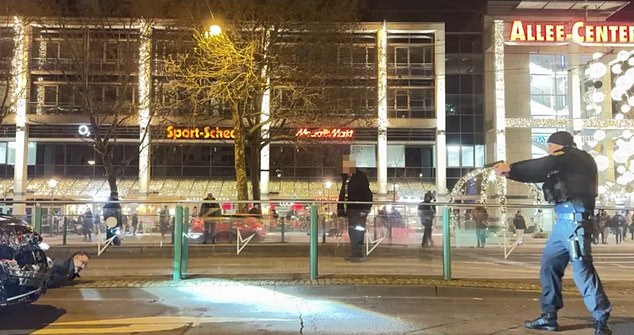 German police can be seen pointing their guns at Abdulmohsen shortly before his arrest yesterday after he rammed a car into a crowd of people at the Magdeburg Christmas market.