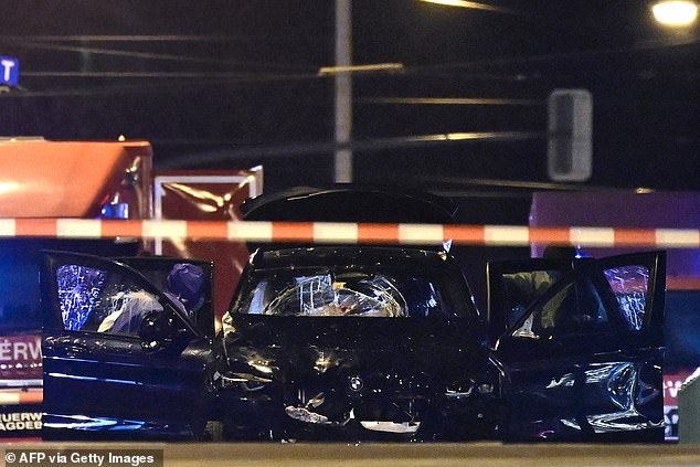 Forensic police inspect the car that plowed into a crowd at a Christmas market in Magdeburg, eastern Germany, on December 21, 2024.