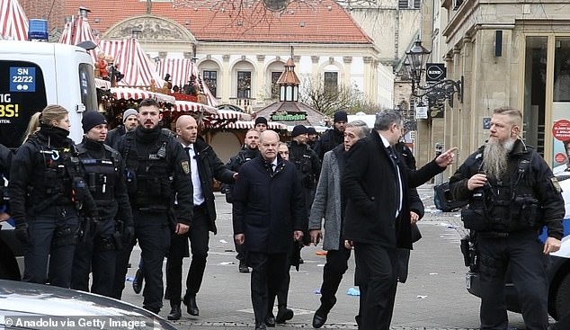 Scholz and his ministers were escorted by police amid hostile cheers from bystanders