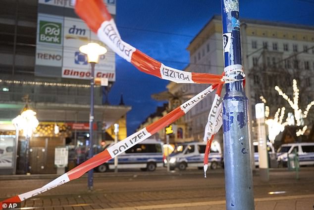 Barrier tape and police vehicles can be seen at the entrance to the Christmas market in Magdeburg