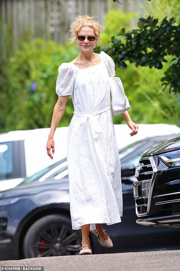 The Australian actress, 57, wore a white dress as she left the service held in the same church where she said goodbye to her mother Janelle just two months ago.