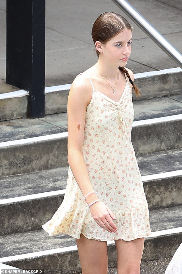 Faith wore a light summer dress with a floral print, spaghetti straps and a gathered neckline.