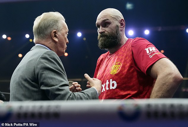 Fury was comforted by Frank Warren (left) inside the ring after the decision was announced.