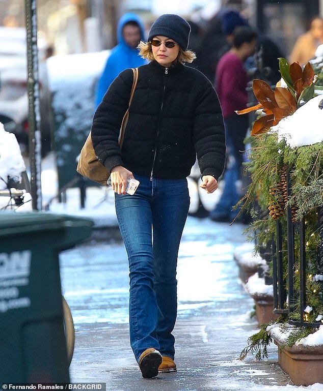 The 29-year-old model wore a black puffer jacket and jeans paired with a beanie and tan winter boots.