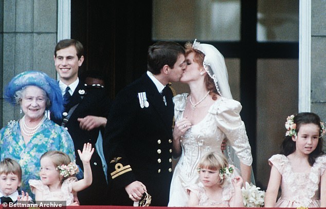 Prince Andrew is seen kissing Sarah on the balcony, after their wedding ceremony at Buckingham Palace.