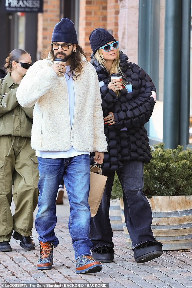 The supermodel and guitarist appeared to be having a relaxing time as they strolled around the celeb-favorite ski resort sipping hot drinks.