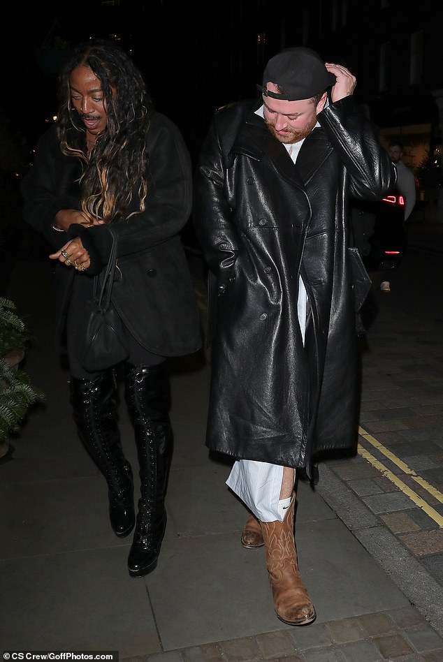 For the festive outing, Sam rocked a pair of distressed brown cowboy boots and wrapped up in a black leather trench coat.