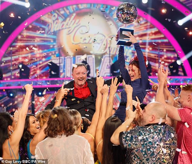 Chris and Dianne couldn't contain their excitement as they triumphantly lifted the Glitterball trophy.