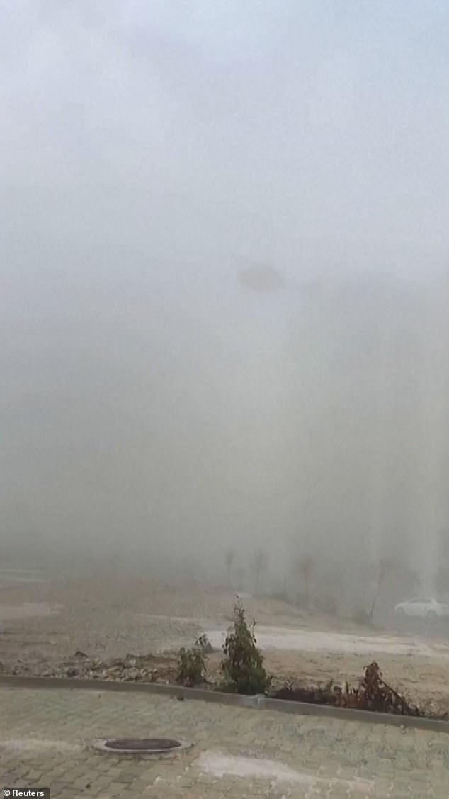 The helicopter is then seen disappearing into the fog as it moves away from the roof of the building.