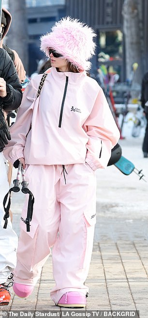 She paired a pink faux fur hat with a matching $280 John Snow 'Mountain Dope Freestyle' two-piece snowsuit.