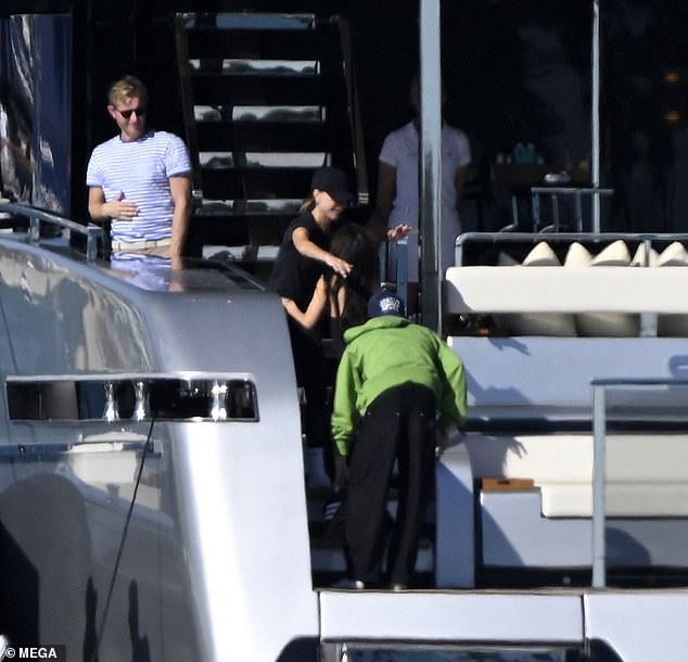 Victoria hugged Jackie as they sunbathed on the deck of the yacht.