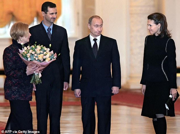 In the photo, Bashar and Asma Al-Assad meet with Vladimir Putin in 2005.