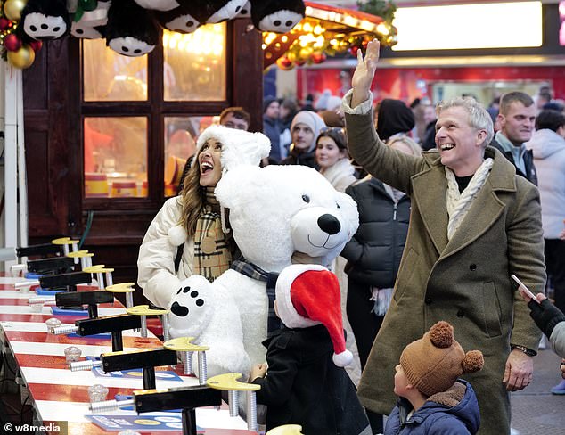 Over the holiday, Myleene and Simon got right into it, riding the rollercoasters and winning Apollo a huge white teddy bear.