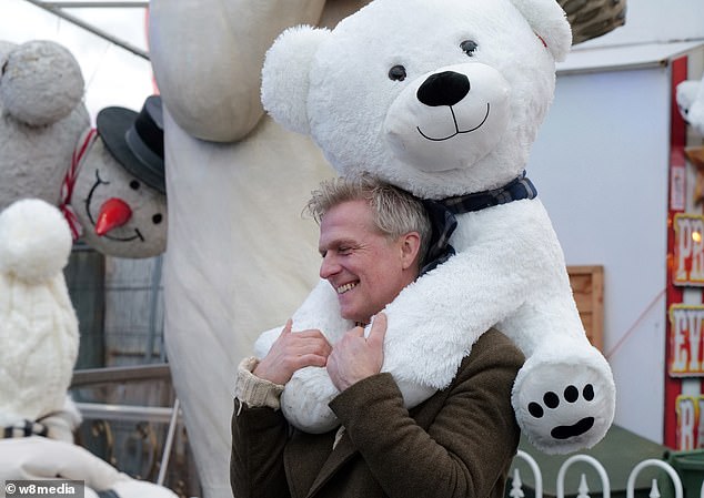 Simon had the honor of holding the giant teddy bear.