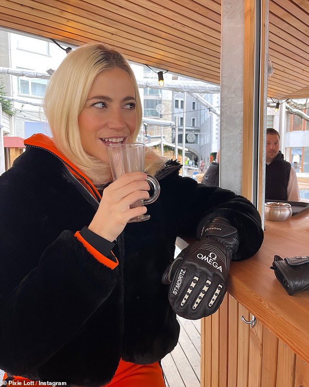 She looked incredible as she kept warm in a pair of Omega gloves while sipping coffee at an outdoor bar.