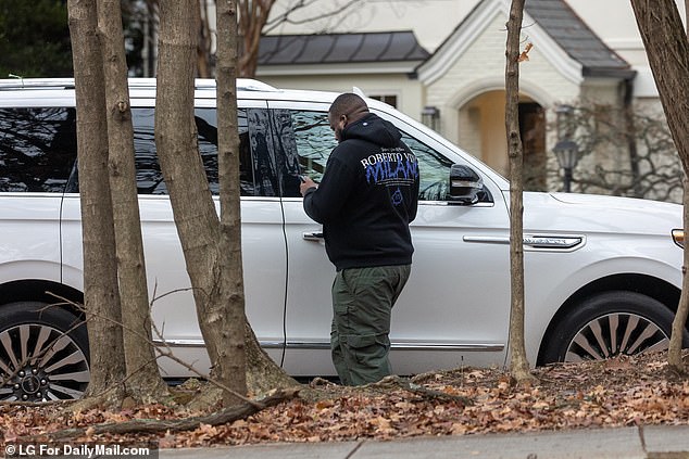 What appears to be a private security guard for Dr. Fauci near the COVID doctor's house