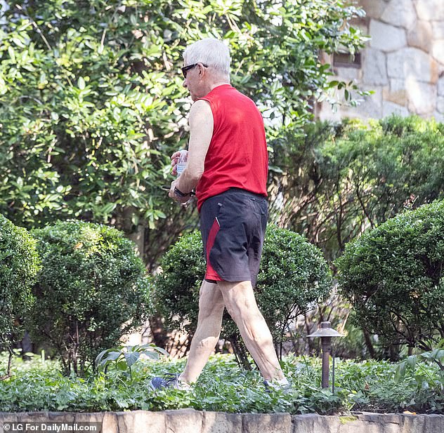 Dr. Anthony Fauci photographed himself outside his home during a walk over the summer. His security guard followed closely behind him