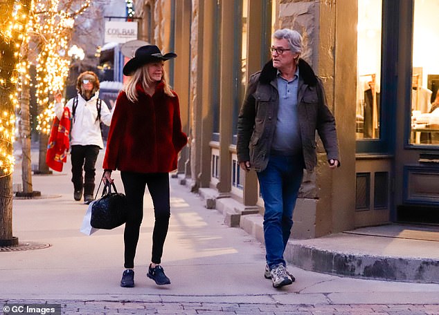 Goldie completed the look with a black clutch, as the pair looked in high spirits, laughing and chatting as they strolled through the streets.