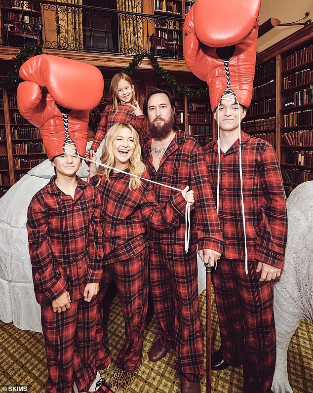 Kate, her sons and daughter posed with Danny with his two children wearing giant boxing gloves on their heads.